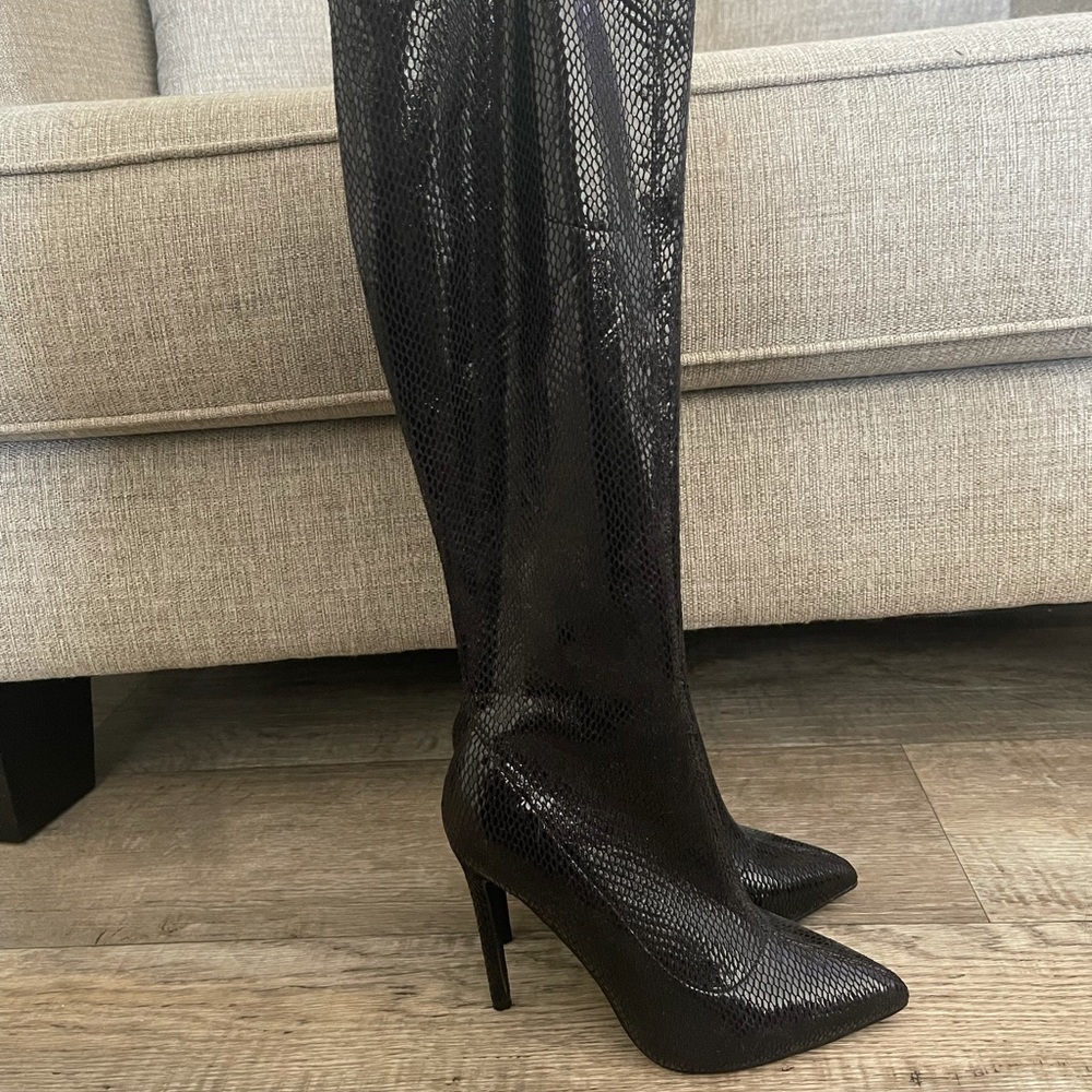Calf height black snake skin heeled boots